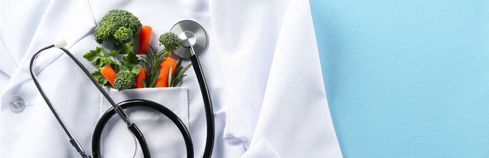 Stethoscope and vegetables in a white coat pocket